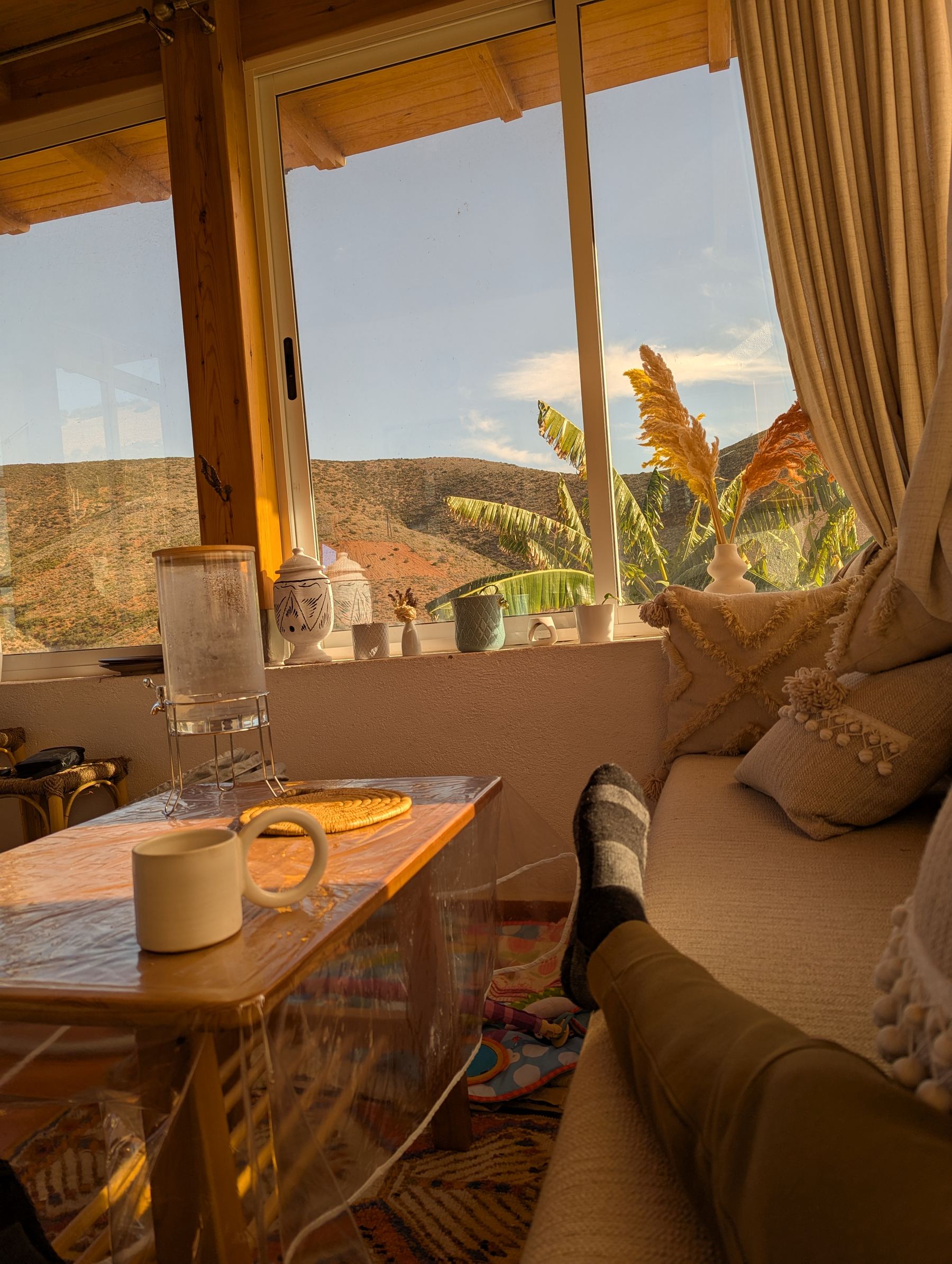 A quiet window nook with tea and a view over the hills