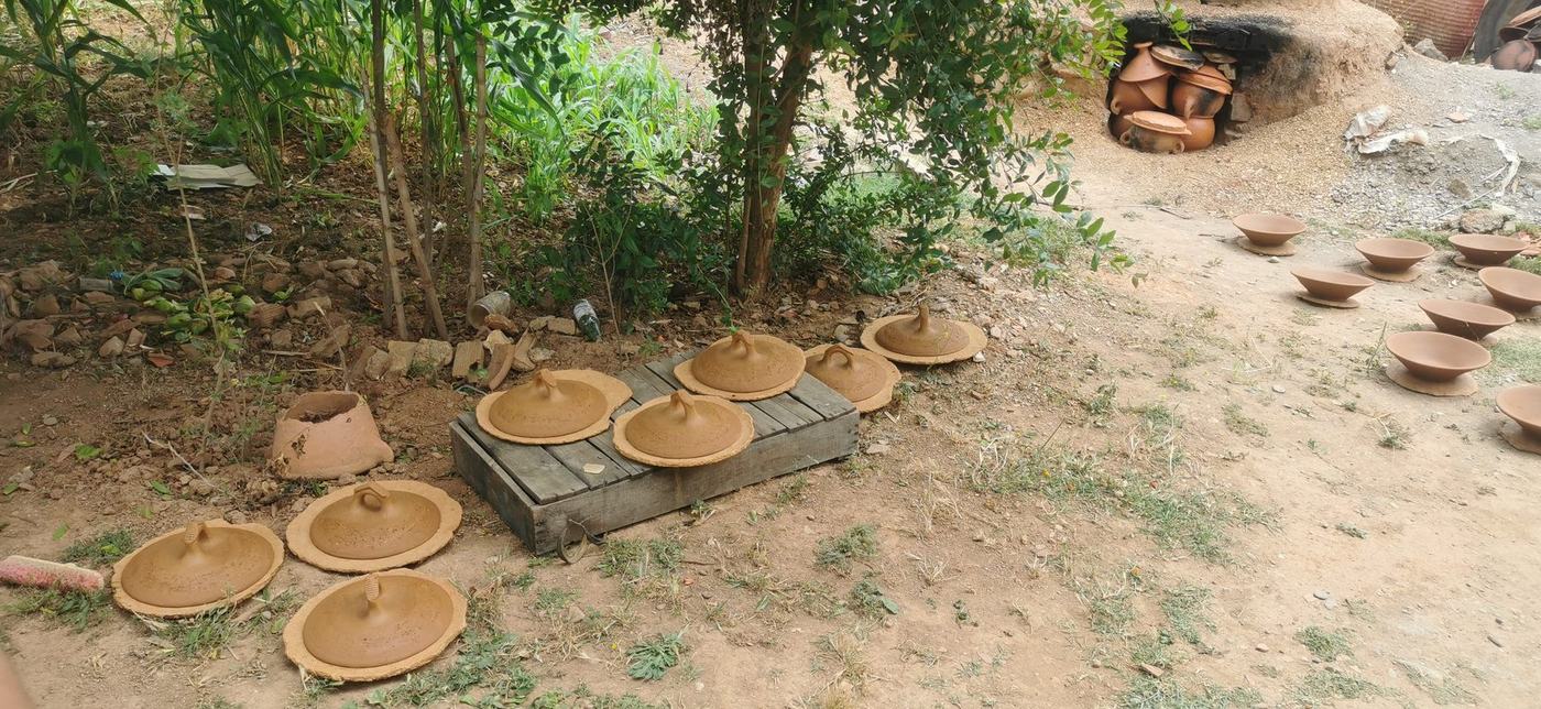 Handmade tagine lids and pottery drying near the kiln in Frane Ali